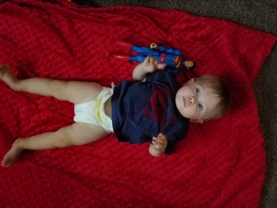 Logan's family captured his growth next to Superman every month during his first year.