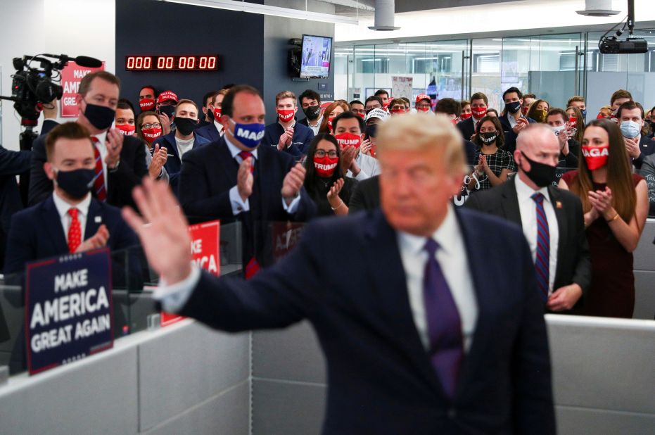 Trump is applauded by his campaign staff as he visits his campaign headquarters in Arlington, Virginia, on Election Day.