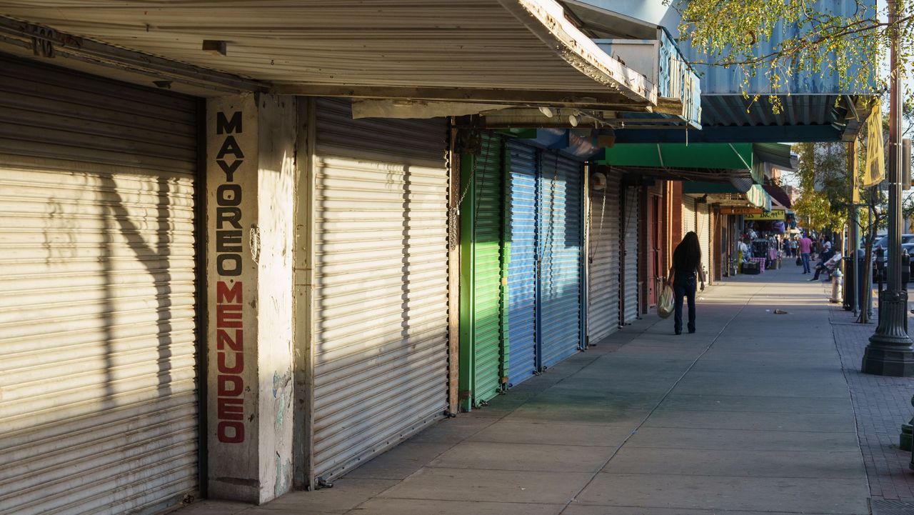 A pedestrian walks down El Paso Street, a major shopping area, on October 23, 2020 in downtown El Paso, Texas. - El Paso's downtown has always been reliant on shoppers from neighboring Ciudad Juarez, but the border closure to non-essential traffic from Mexico has hurt businesses, whose main clientele is Mexican shoppers. (Photo by Paul Ratje/AFP/Getty Images)