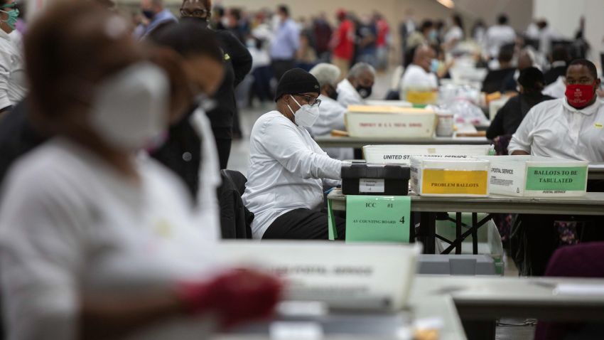 DETROIT, MI - NOVEMBER 04: A worker with the Detroit Department of Elections helps process an absentee ballot at the Central Counting Board in the TCF Center on November 4, 2020 in Detroit, Michigan. After a record-breaking early voting turnout, Americans head to the polls on the last day to cast their vote for incumbent U.S. President Donald Trump or Democratic nominee Joe Biden in the 2020 presidential election.  (Photo by Elaine Cromie/Getty Images)