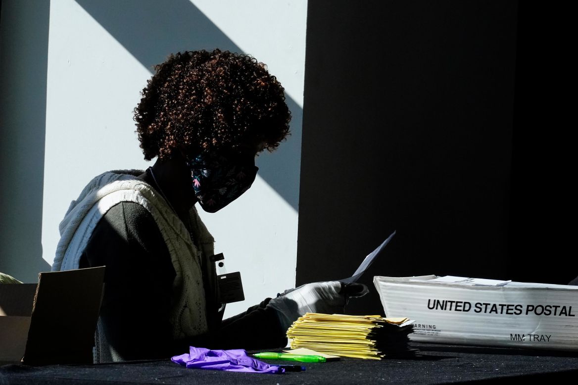 An election worker handles ballots as vote counting continued in Atlanta on Wednesday, November 4.