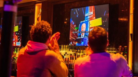 People react to the state of California staying a Democrat state during the election night in West Hollywood, California, November 3.