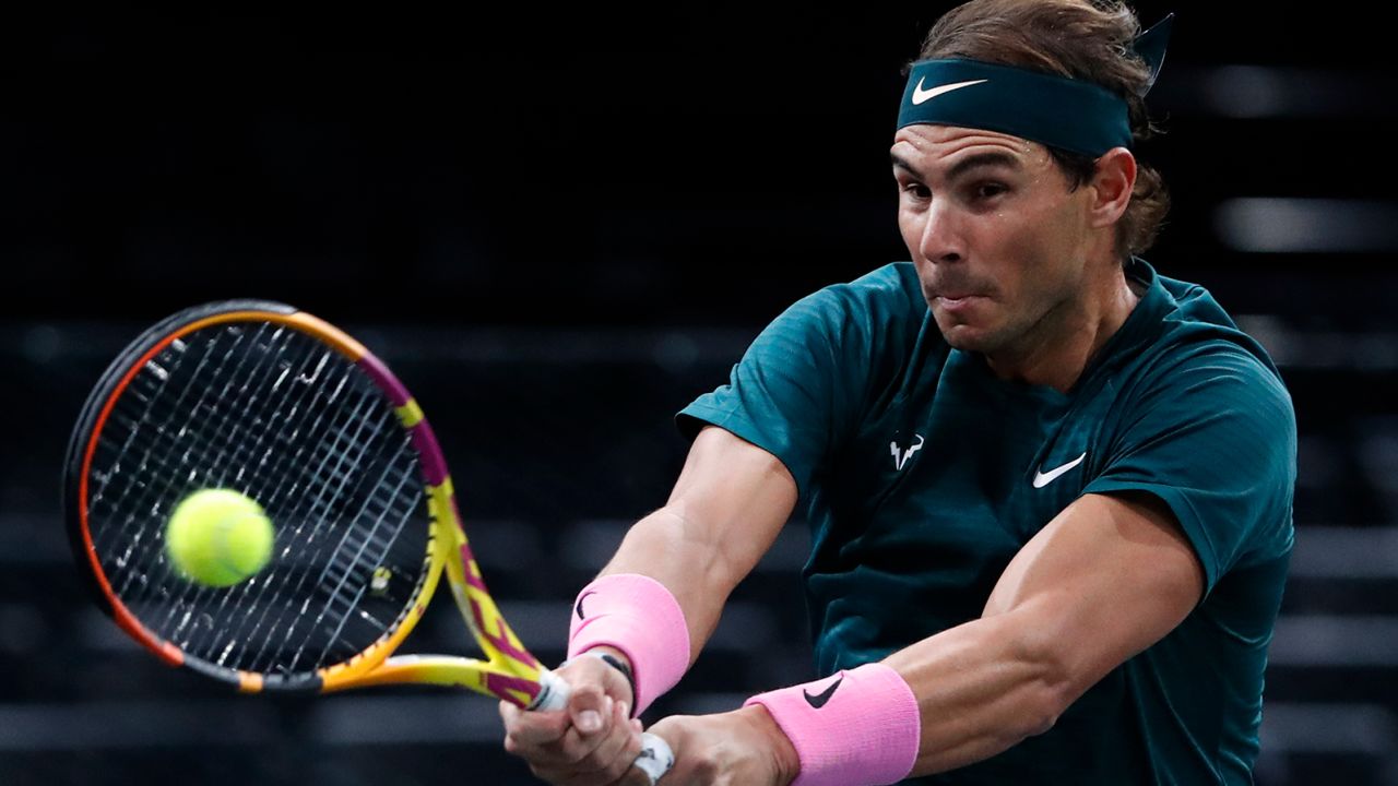 Nadal returns a backhand to compatriot Lopez.