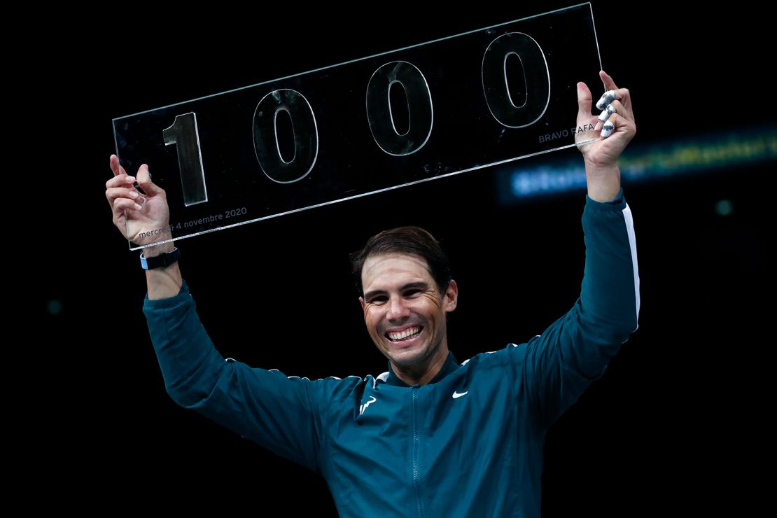 Nadal poses with the trophy of his 1000th victory.