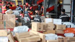 Workers sort out packages at a delivery company after "Singles' Day" -- the world's biggest 24-hour shopping event -- in Yangzhou in China's eastern Jiangsu province on November 13, 2019. Chinese shoppers set new records for spending during the annual "Singles' Day" buying spree despite an economic slowdown and worries over the US trade war, with state media calling it a sign of China's rising economic strength. E-commerce giant Alibaba said consumers spent $38.3 billion on its platforms on November 11 during the world's biggest 24-hour shopping event, up 26 percent from the previous all-time high mark set last year. (Photo by STR/AFP/Getty Images)