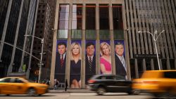 Traffic on Sixth Avenue passes by advertisements featuring Fox News personalities, including Bret Baier, Martha MacCallum, Tucker Carlson, Laura Ingraham, and Sean Hannity, adorn the front of the News Corporation building, March 13, 2019 in New York City. On Wednesday the network's sales executives are hosting an event for advertisers to promote Fox News. Fox News personalities Tucker Carlson and Jeanine Pirro have come under criticism in recent weeks for controversial comments and multiple advertisers have pulled away from their shows. (Photo by Drew Angerer/Getty Images)