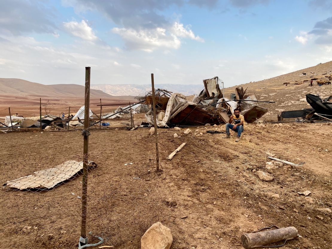 A man sits at the site of the demolition in Khirbet Humsa on November 4.