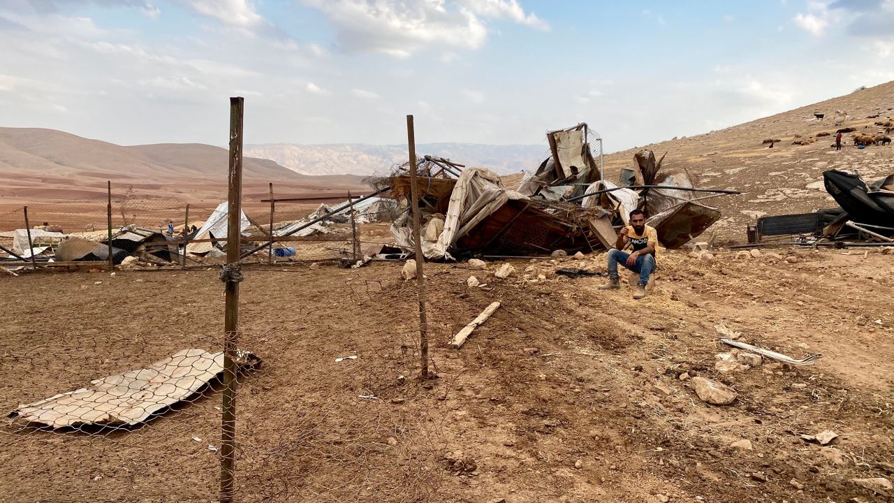 A man sits at the site of the demolition in Khirbet Humsa on November 4.
