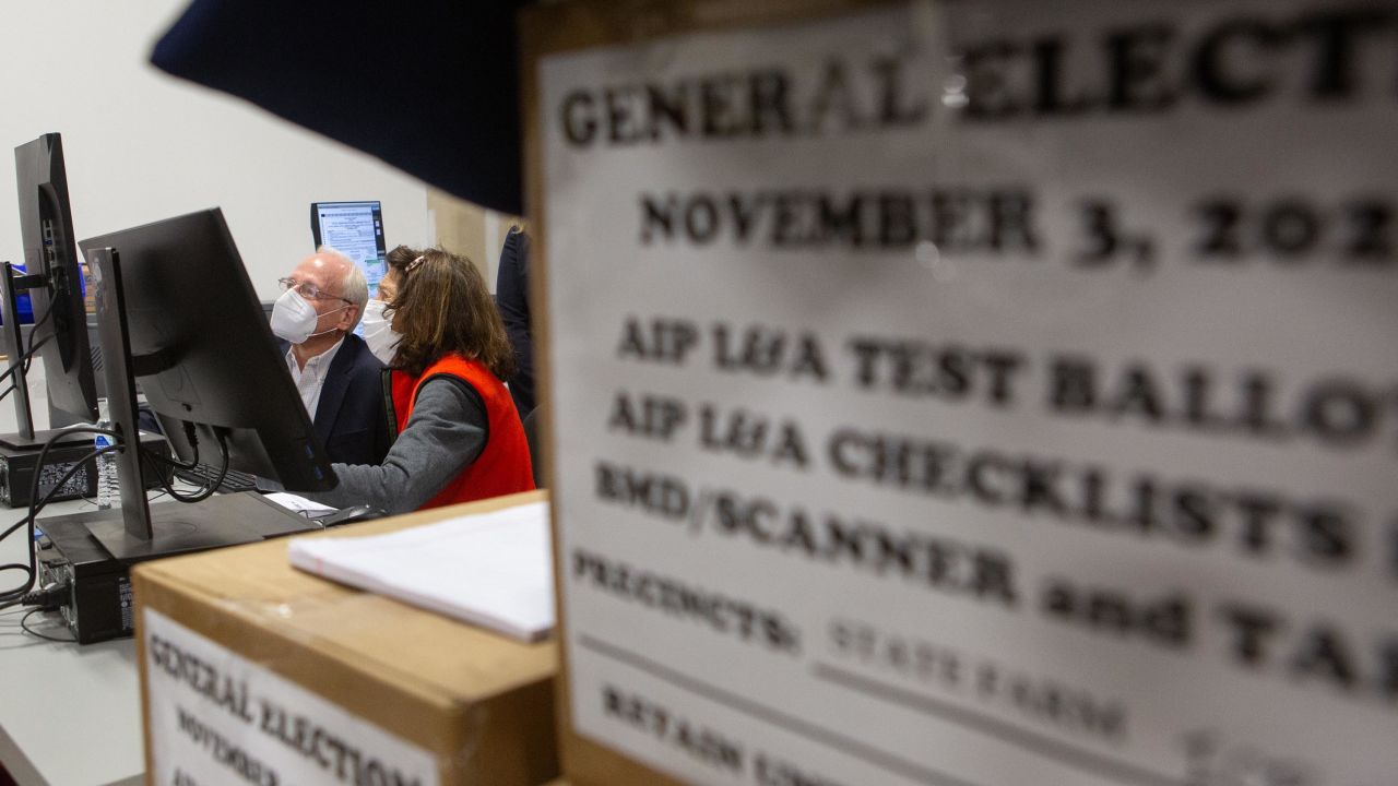 Members of an adjudication review panel look over scanned absentee ballots at the Fulton County Election Preparation Center on November 4, 2020, in Atlanta.