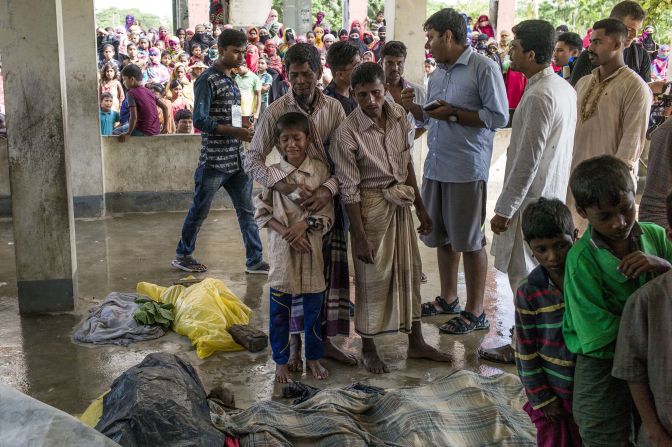 Rohingya refugees mourn beside the bodies of relatives who died <a href="index.php?page=&url=http%3A%2F%2Fwww.cnn.com%2F2017%2F09%2F29%2Fasia%2Frohingya-refugee-boat-capsize%2Findex.html">when a boat capsized</a> in late September.