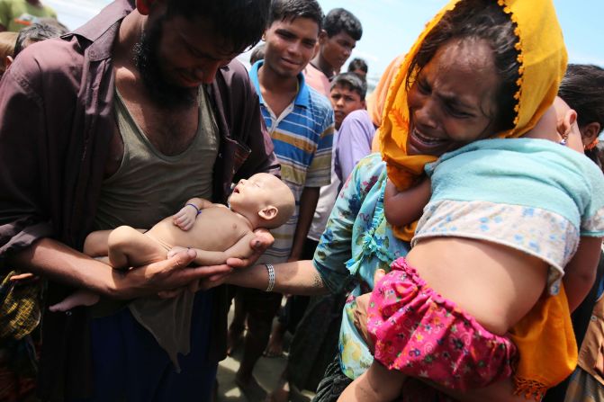 Rohingya refugees fleeing Myanmar hold their infant son Abdul Masood, <a href="index.php?page=&url=http%3A%2F%2Fwww.cnn.com%2F2017%2F09%2F14%2Fasia%2Fmyanmar-rohingya-muslim-family-mourns-infant-son%2Findex.html" target="_blank">who died when their boat capsized</a> before reaching Bangladesh on September 13.