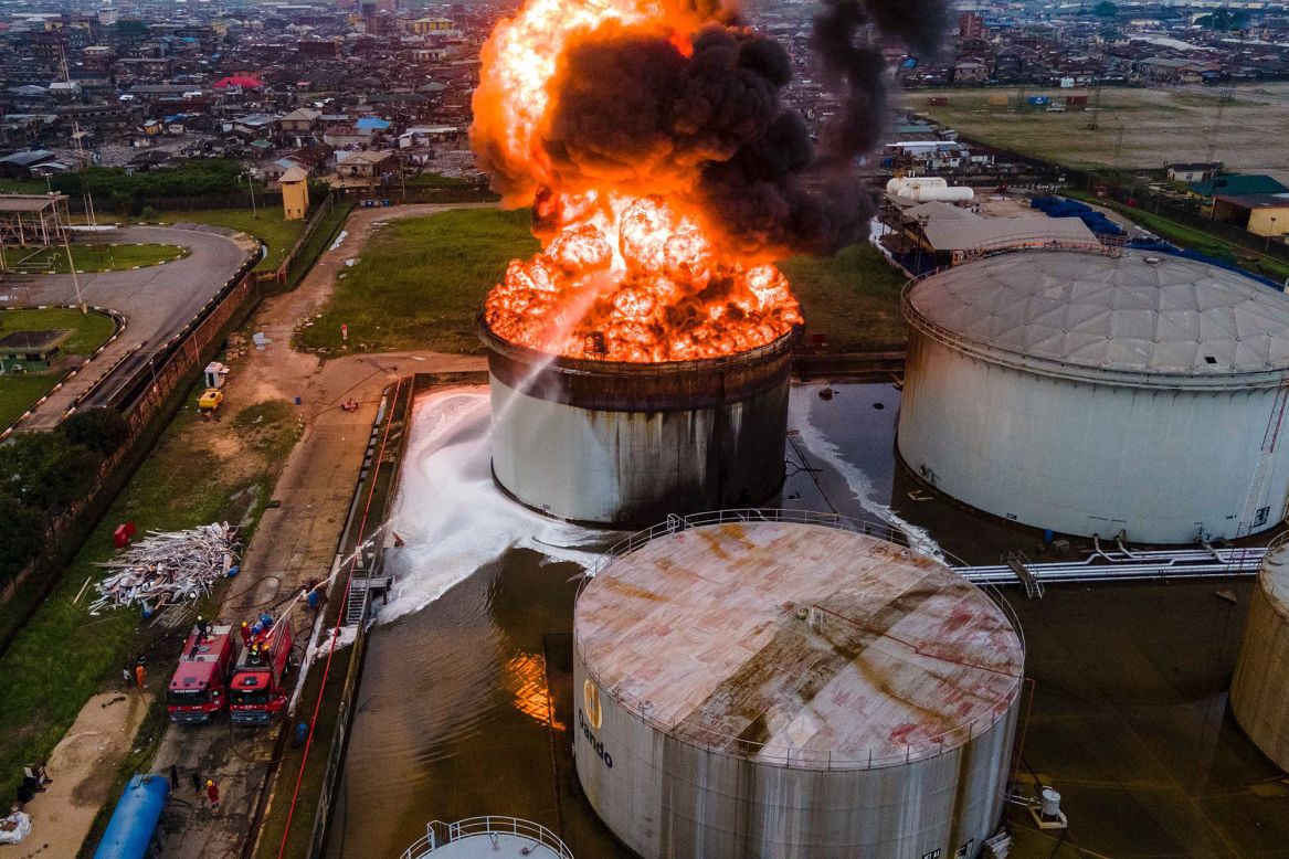 Firefighters try to control a burning oil tanker in Lagos, Nigeria, on Thursday, November 5. The cause of the fire was not immediately known.