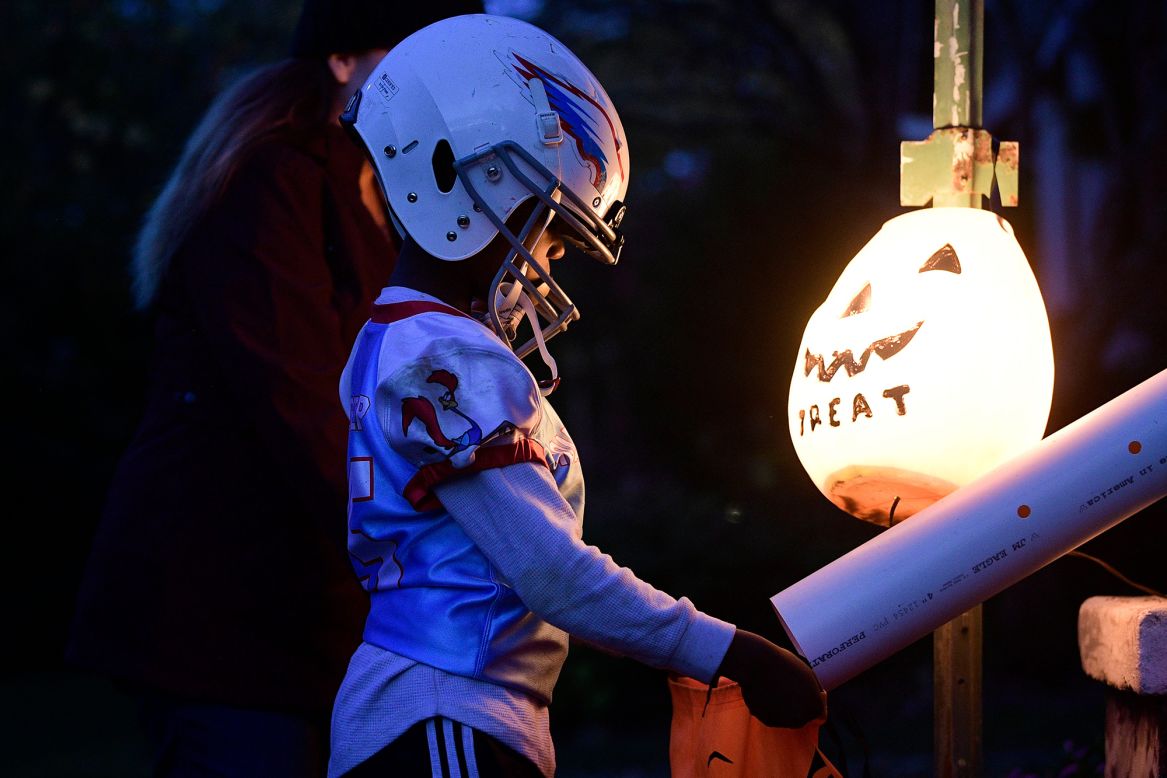 A child gets candy from a chute while trick-or-treating in Knoxville, Tennessee, on Saturday, October 31.