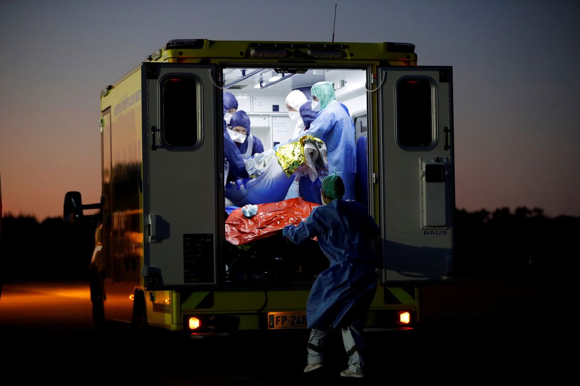 Medical staff members transfer a Covid-19 patient who had arrived by plane near Vannes, France, on Wednesday, November 4. A day earlier, <a href="https://www.cnn.com/2020/11/04/europe/england-italy-lockdown-covid-deaths-europe-intl/index.html" target="_blank">France reported 854 Covid-19 deaths in 24 hours</a> — an average of one person dying every 1 minute 41 seconds. It was the nation's highest daily tally since April 15, according to data released by the French Health Authority.
