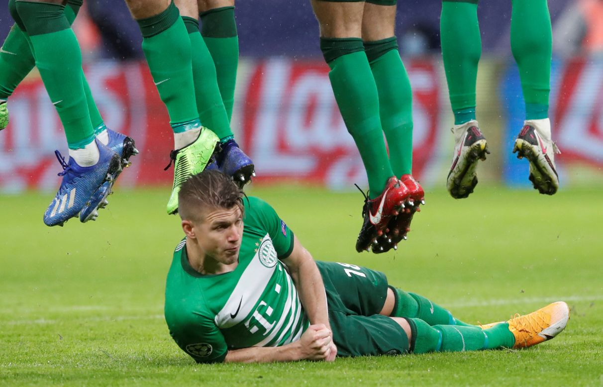 Ferencvaros' David Siger lies on the ground to defend a free kick during a Champions League soccer game in Budapest, Hungary, on Wednesday, November 4.