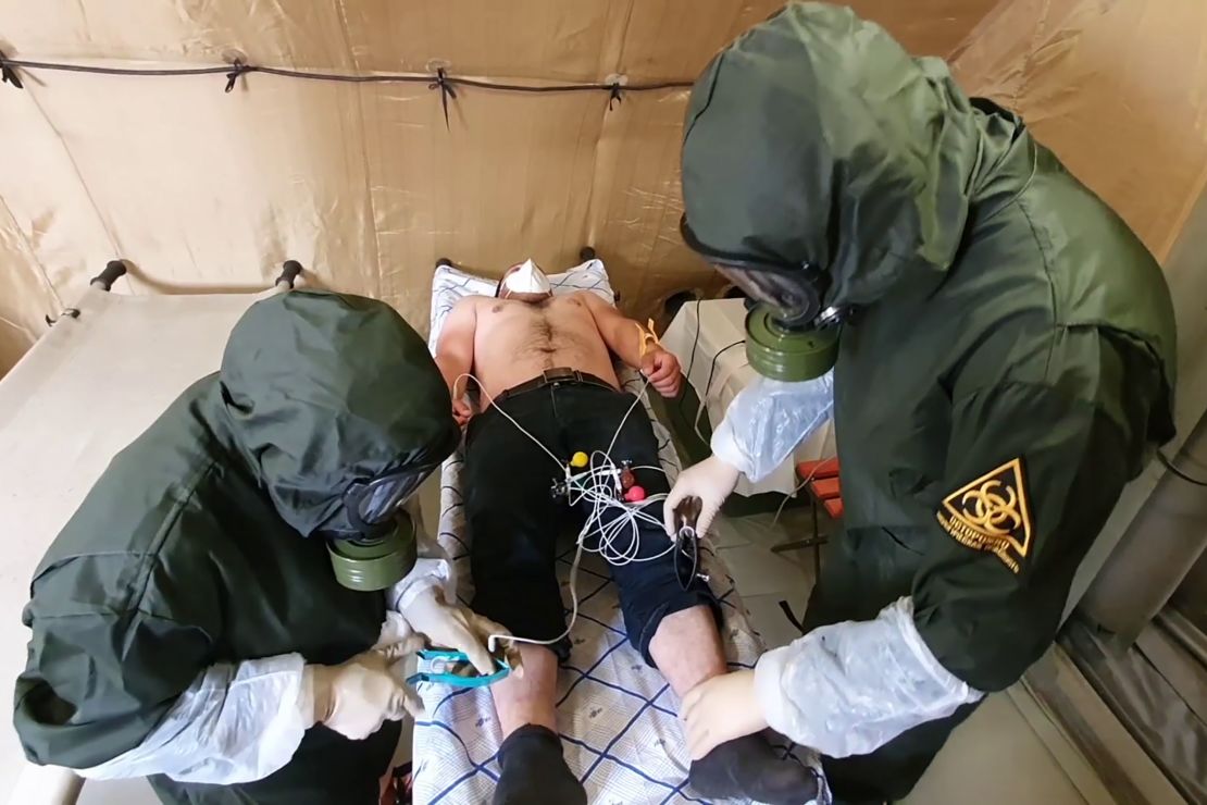 Medical staff examine a person on May 25, 2020, at a multifunctional field hospital for coronavirus patients built by the Russian Defense Ministry in Buynaksk, Dagestan.