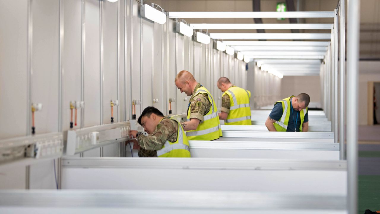 Members of the military and private contractors help to transform the ExCel centre in London into an NHS Nightingale Hospital for coronavirus patients, on March 30, 2020.