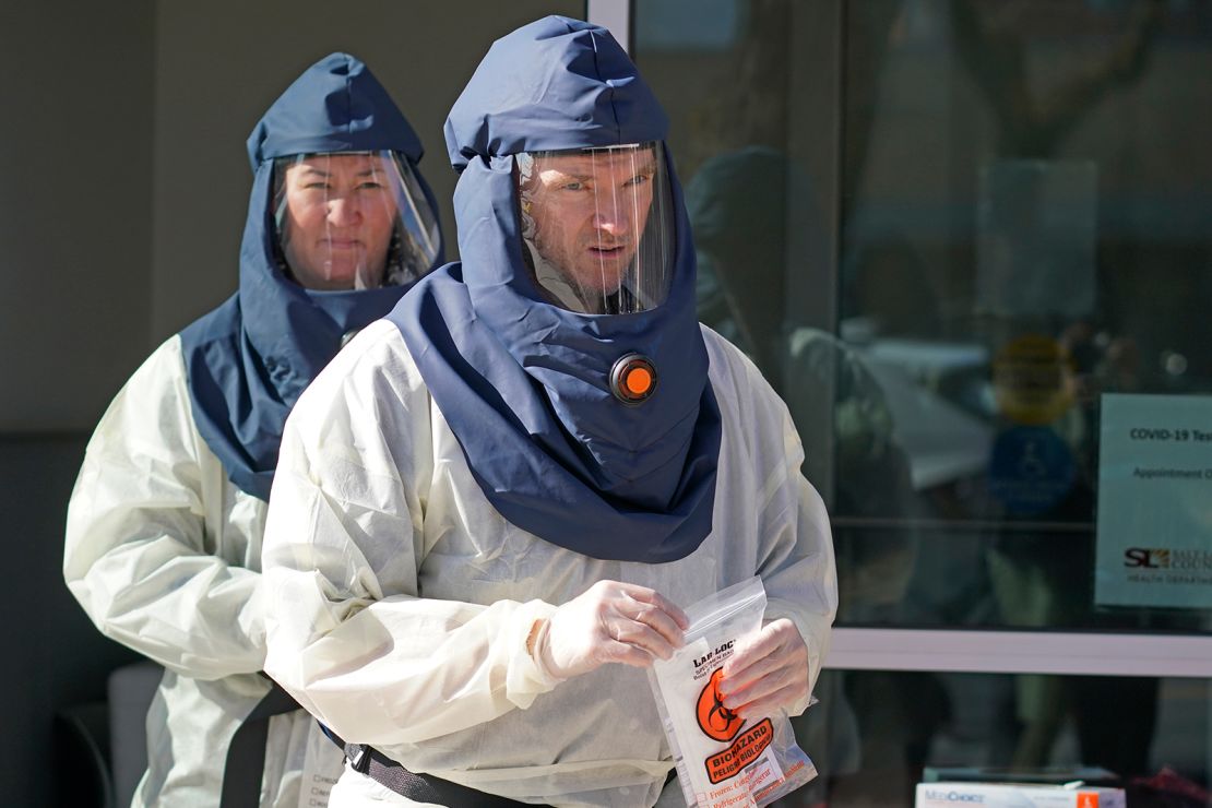 Salt Lake County Health Department public health nurses look on during coronavirus testing outside the department in Salt Lake City on Tuesday, November 3. 