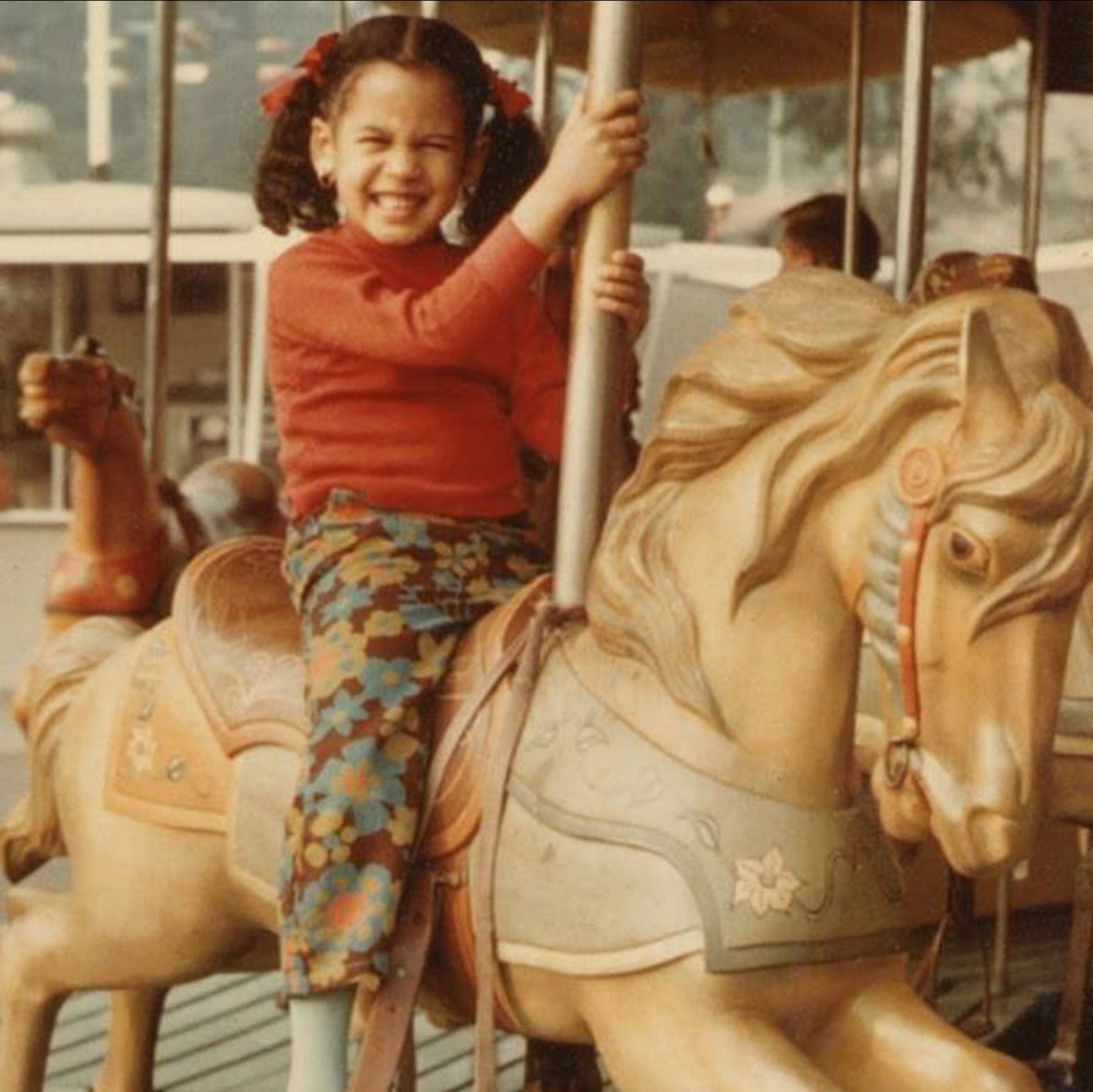 Harris rides a carousel in this old photo <a href="index.php?page=&url=https%3A%2F%2Fwww.instagram.com%2Fp%2F3g64_Qrv3_%2F" target="_blank" target="_blank">she posted to social media in 2015.</a> Her name, Kamala, comes from the Sanskrit word for the lotus flower. Harris is the daughter of Jamaican and Indian immigrants and grew up attending both a Baptist church and a Hindu temple.