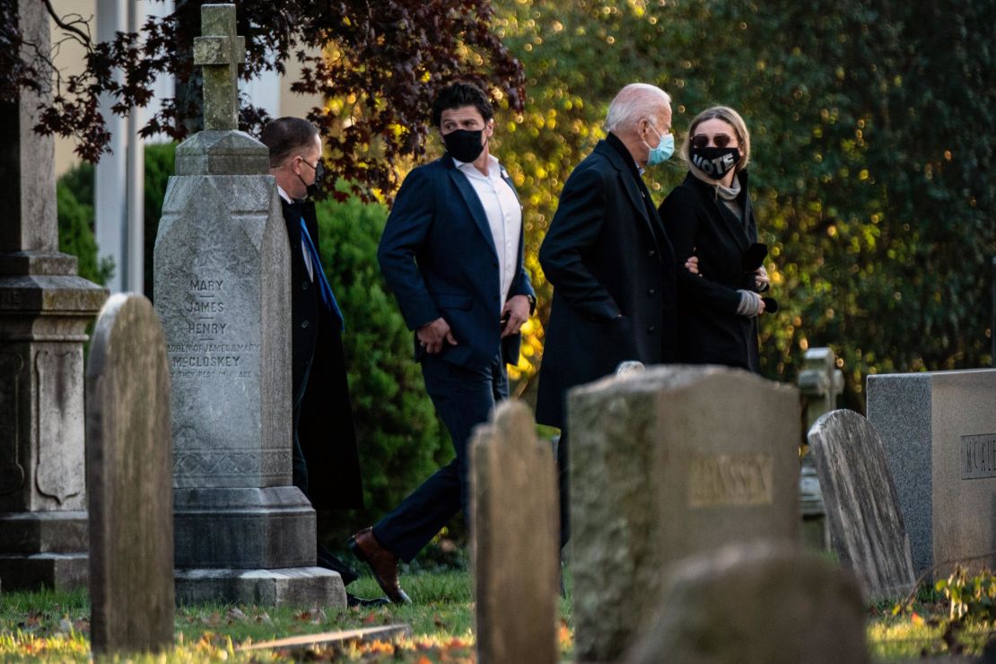 Former Vice President Joe Biden, the Democratic presidential nominee, walks arm in arm with his granddaughter Finnegan Biden as they arrive to visit the grave of his son Beau Biden at St. Joseph on the Brandywine Church in Wilmington, Del., on Election Day morning.