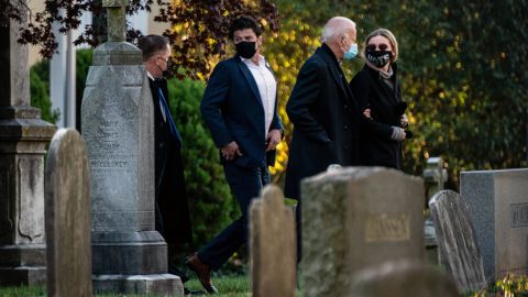 Former Vice President Joe Biden, the Democratic presidential nominee, walks arm in arm with his granddaughter Finnegan Biden as they arrive to visit the grave of his son Beau Biden at St. Joseph on the Brandywine Church in Wilmington, Del., on Election Day morning.