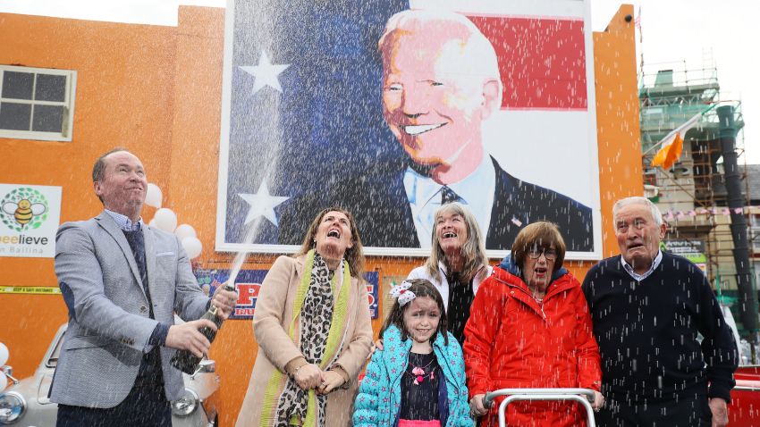 Joe Blewitt (left), a cousin of US Presidential candidate Joe Biden, with (from left) his wife Deirdre, daughter Lauren (7), Emer Bourke, his aunt Breege Bourke and his father Brendan Blewitt as they begin celebrating in anticipation of the results of the US election as Biden edges closer to victory over Donald Trump, at a mural of Biden in his ancestral home of Ballina, Co. Mayo, Ireland. (Photo by Brian Lawless/PA Images via Getty Images)