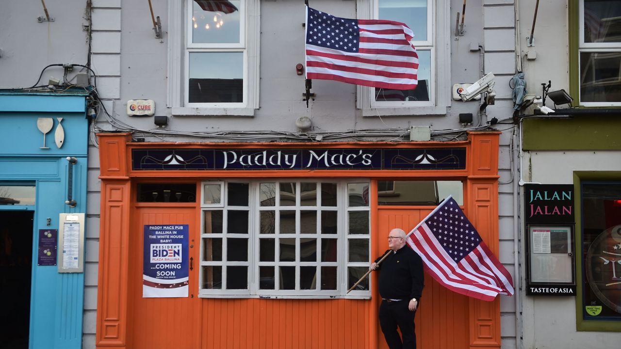 Paddy Macs bar owner Michael Carr stands outside his pub with an American flag on November 7, 2020.