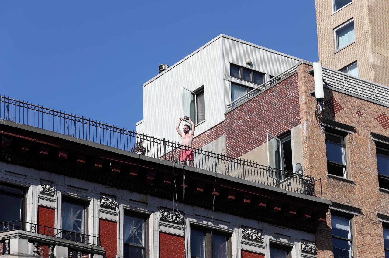A man reacts from a rooftop in New York.