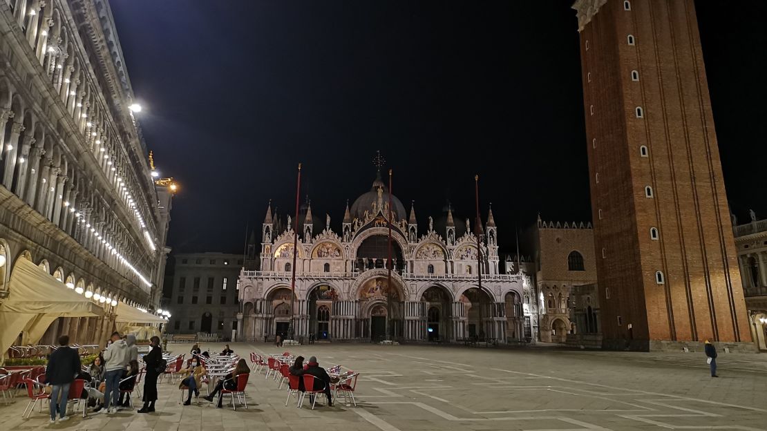 Locals take to the cafe seating in St Mark's Square during Italy's second semi-lockdown, 6 November 2020