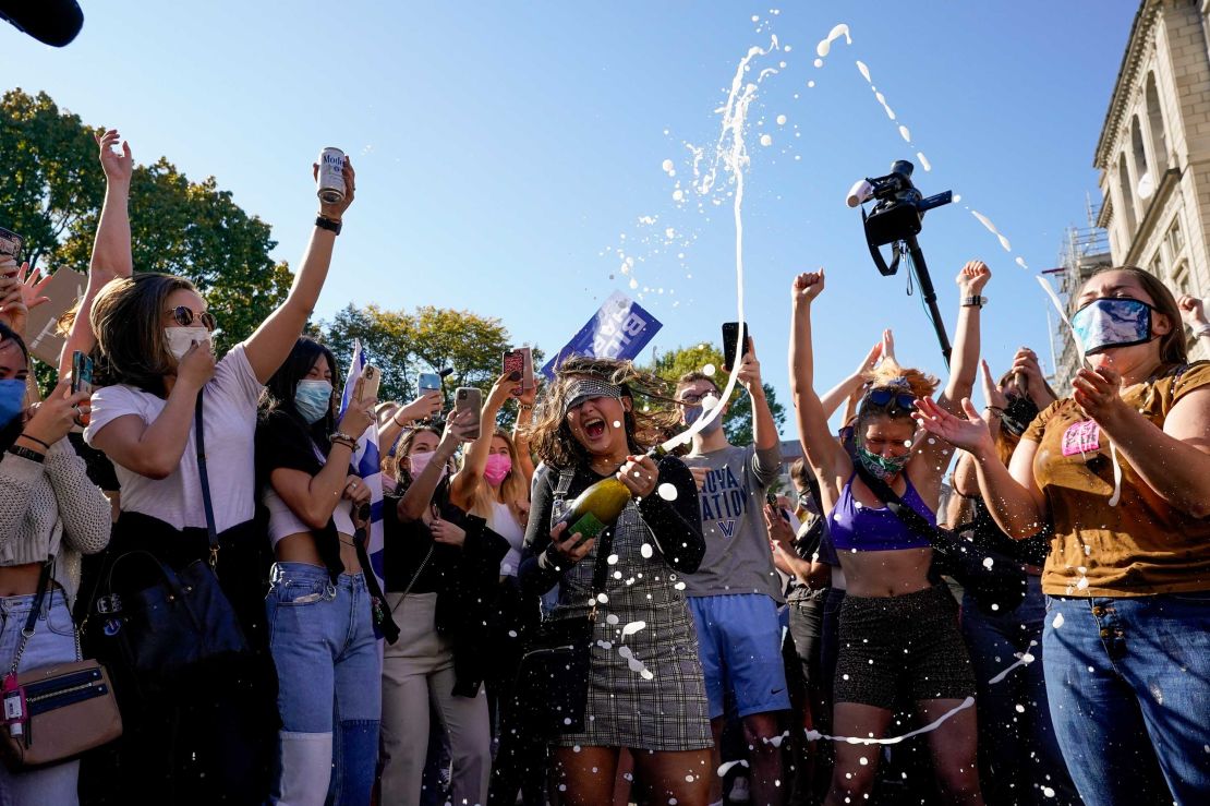 Amanda Madden sprays champagne as people celebrate at Black Lives Matter Plaza on November 7, 2020.