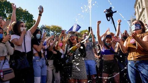 Amanda Madden sprays champagne as people celebrate at Black Lives Matter Plaza on November 7, 2020.