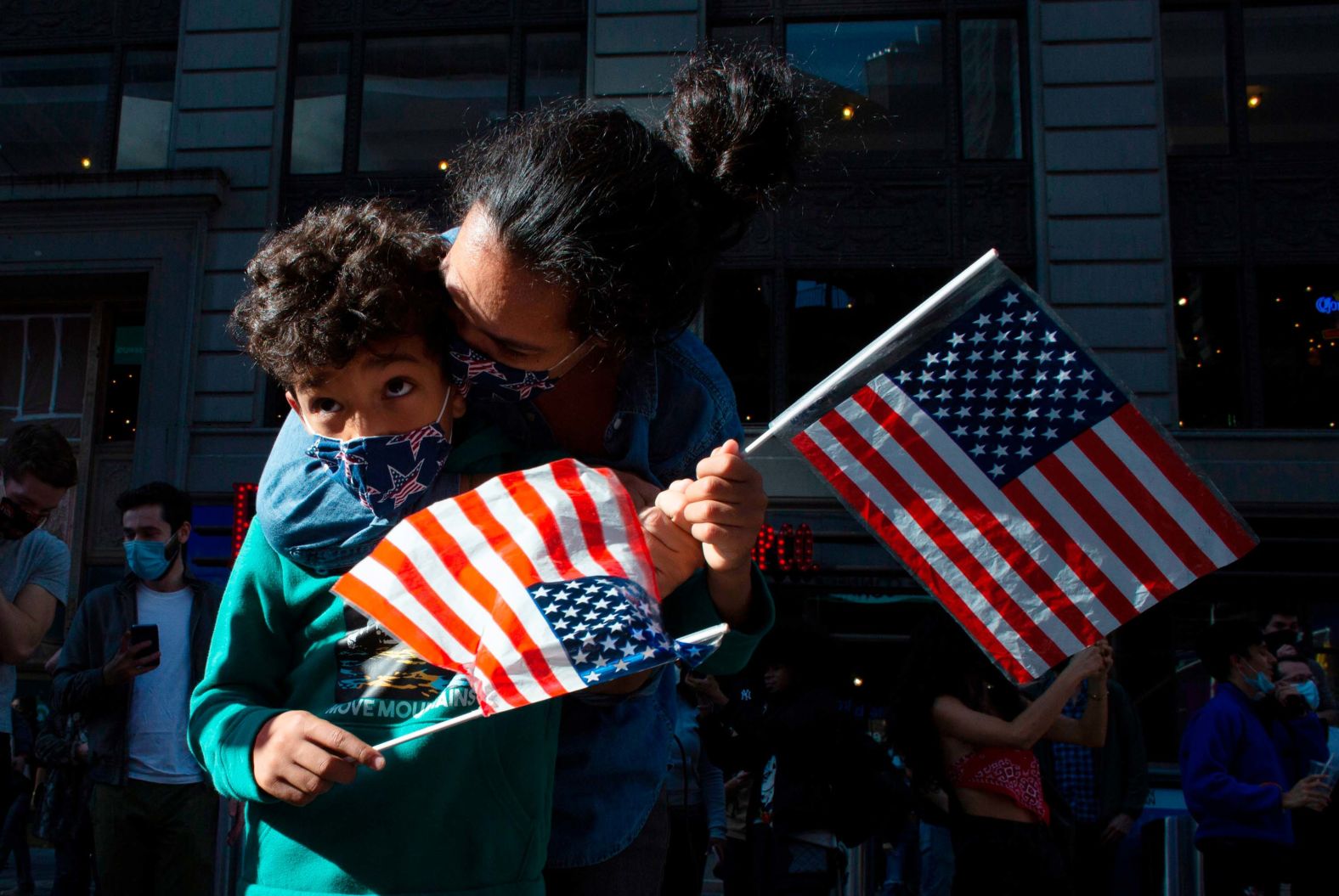 People wave American flags at Times Square in New York.