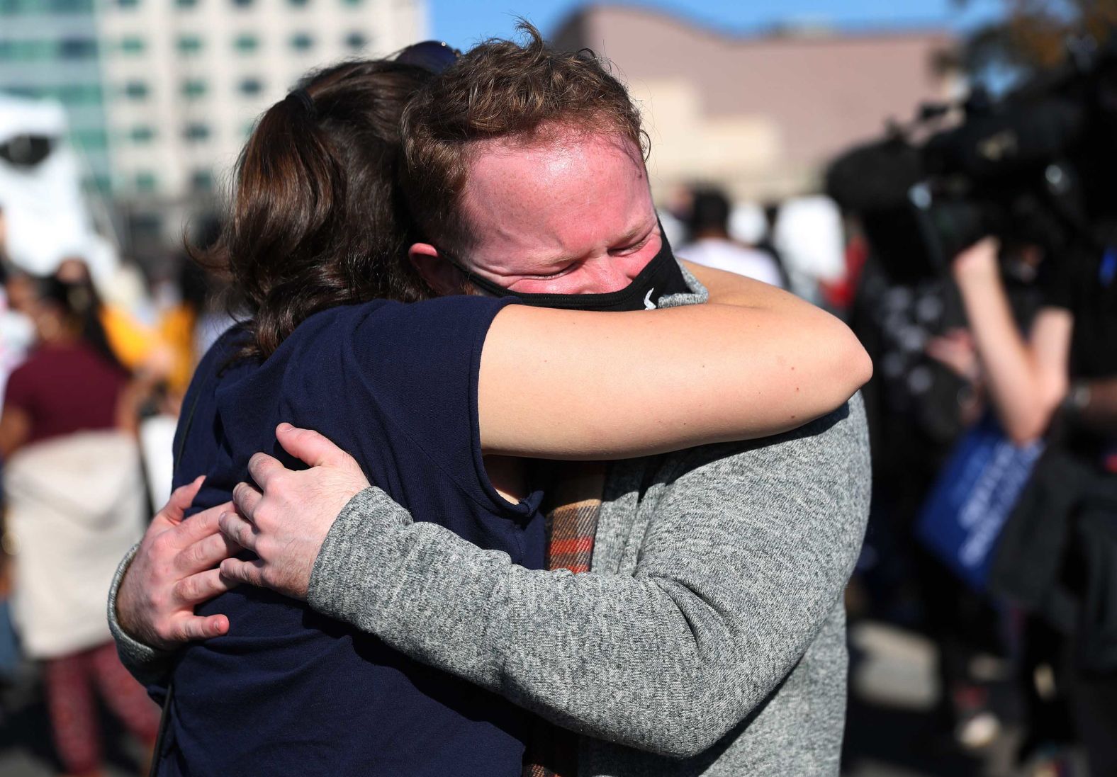 Gabi Poletaev and Michael Crowley hug outside the Chase Center in Wilmington, Delaware.