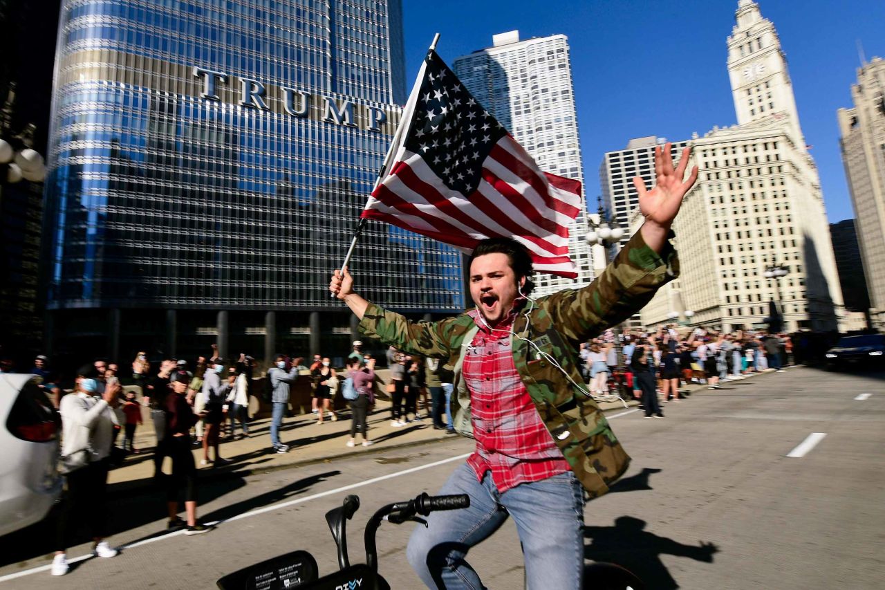A Biden supporter celebrates while riding a bike outside Trump Tower in Chicago.