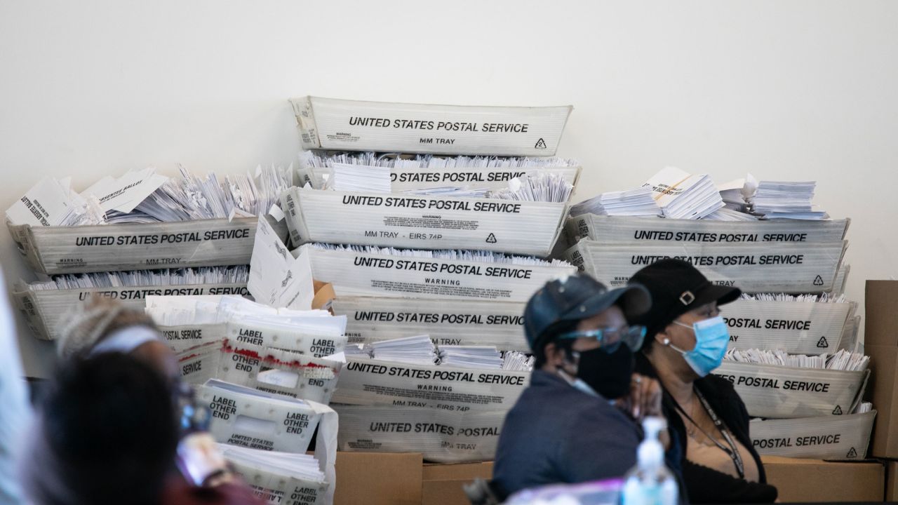 Security envelopes for absentee ballots sit in stacked boxes as Fulton County workers count absentee ballots on November 6. 