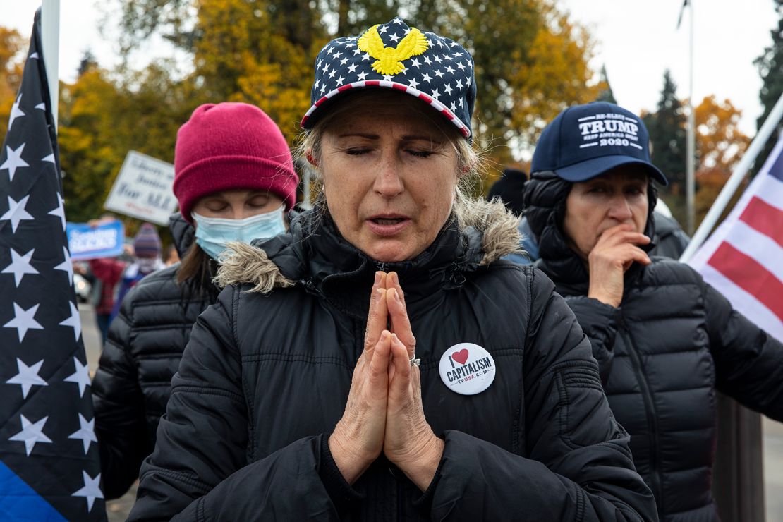 Supporters of President Donald Trump pray during a rally to protest against President-elect Joe Biden's win Saturday, Nov. 7, 2020 in Salem, Ore. 