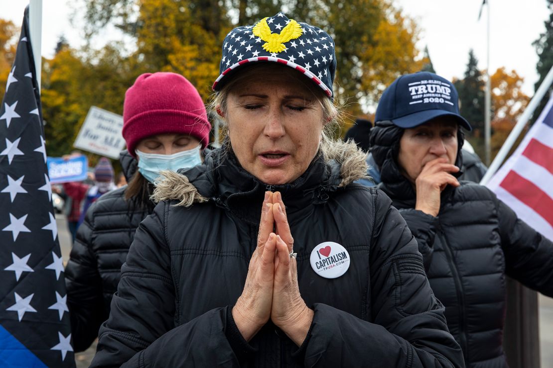 Supporters of President Donald Trump pray during a rally to protest against President-elect Joe Biden's win Saturday, Nov. 7, 2020 in Salem, Ore.