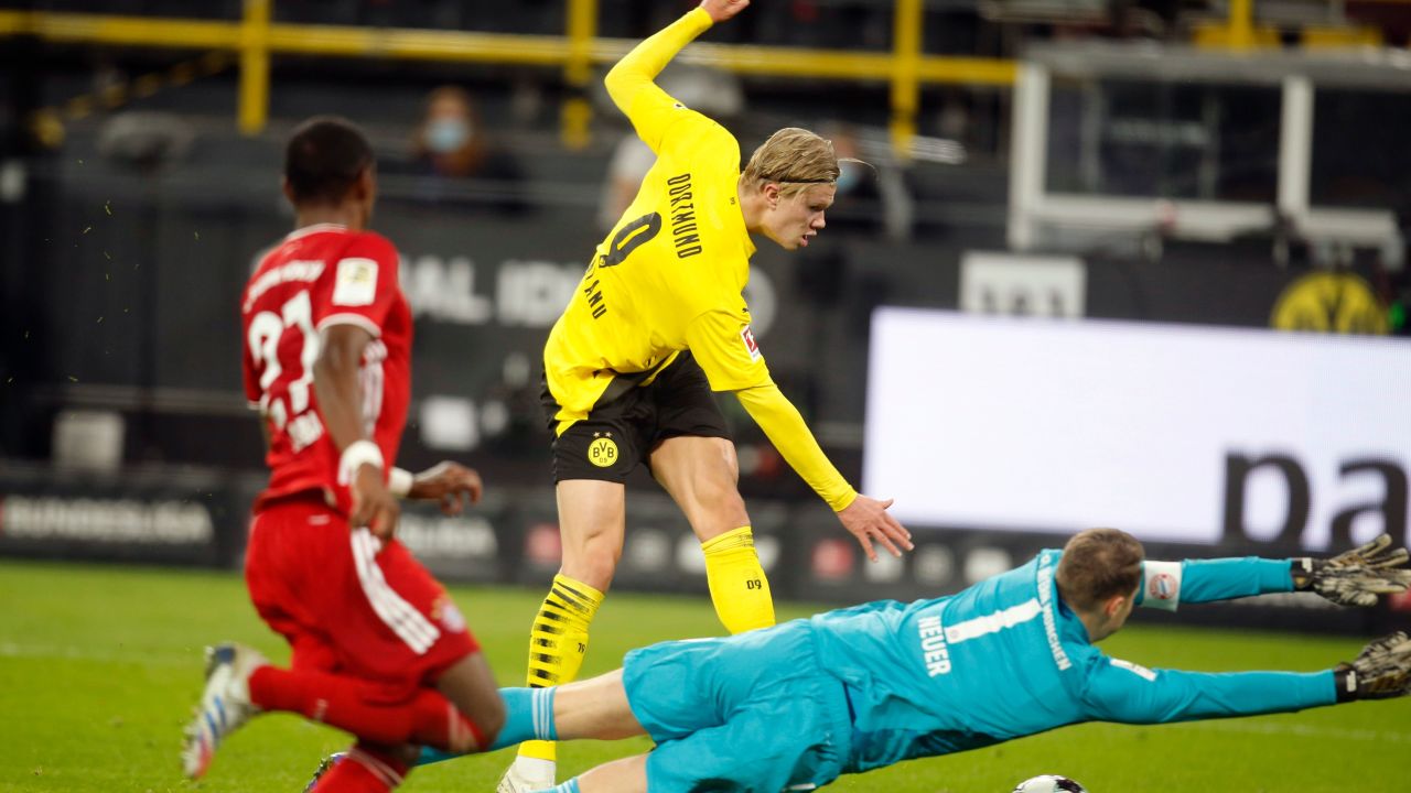 Dortmund's Norwegian forward Erling Braut Haaland (C) scores Dortmund's second goal in the 3-2 defeat by Bayern Munich.