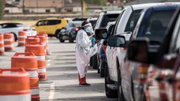 EL PASO, TX - OCTOBER 31: An attendant talks to a person waiting in their car at a coronavirus testing site at Ascarate Park on October 31, 2020 in El Paso, Texas. As El Paso reports record numbers of active coronavirus cases, the Texas Attorney General sues to block local shutdown orders. (Photo by Cengiz Yar/Getty Images)
