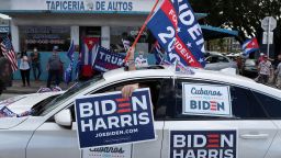 MIAMI, FLORIDA - OCTOBER 18: A caravan of supporters for Democratic presidential nominee Joe Biden drive past supporters of President Donald Trump standing on the sidewalk next to the Versailles Restaurant during a Worker Caravan for Biden event on October 18, 2020 in Miami, Florida. The caravan was part of a countywide caravan put together by union workers, activists and supporters of Joe Biden the day before polls opened for early voting in the general election. (Photo by Joe Raedle/Getty Images)