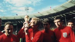 England captain Bobby Moore kissing the Jules Rimet trophy as the team celebrate winning the 1966 World Cup final against Germany at Wembley Stadium. His team mates are, left to right, George Cohen, Geoff Hurst and Martin Peters, 30th July 1966. (Photo by Hulton Archive/Getty Images)