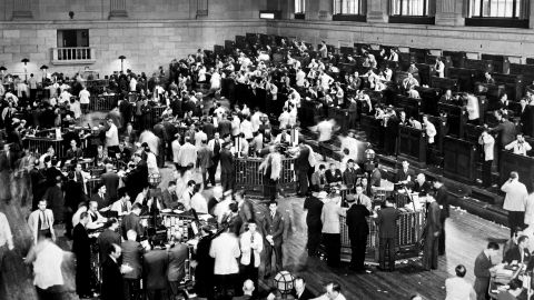 Traders rush in 1929 as the New York Stock Exchange crashes, sparking a run on banks.