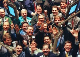 Traders cheer on the floor of the New York Stock Exchange in March 1999, as the Dow hit the 10,000  mark for the first time. By the end of the month it would close above that level.