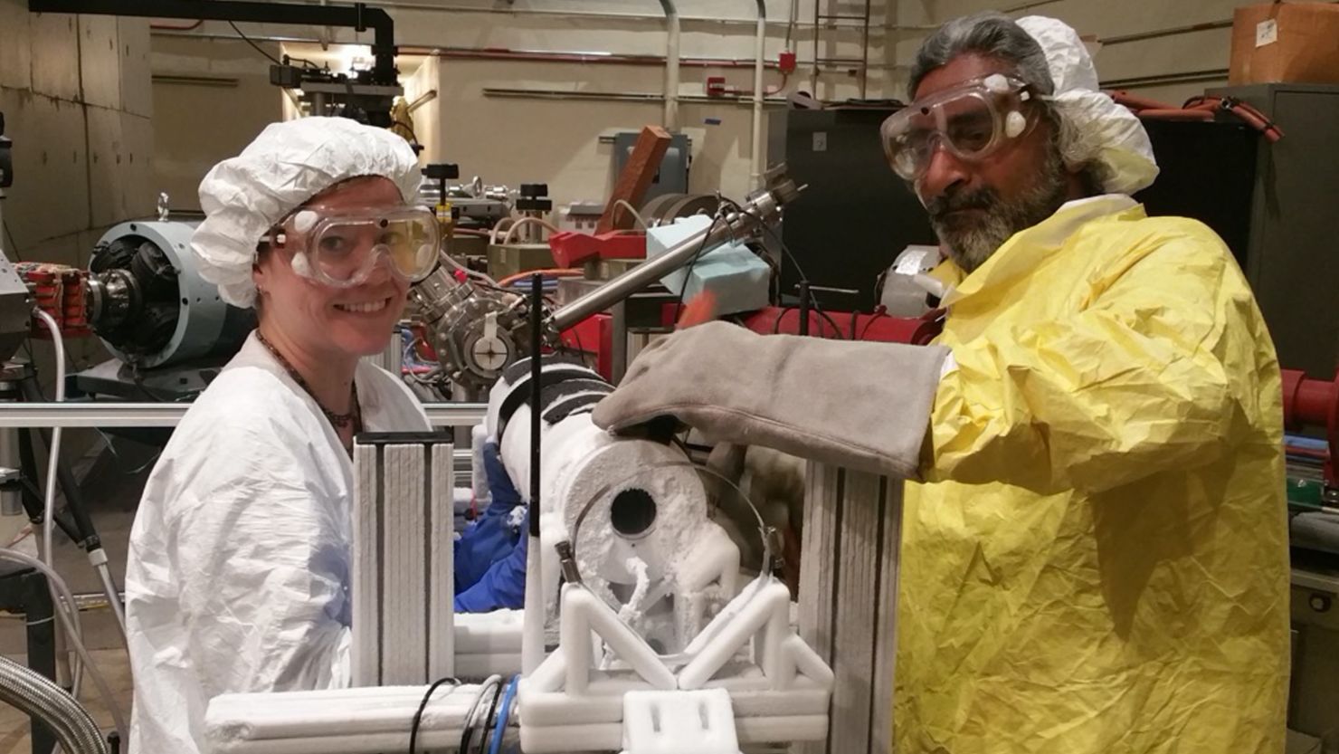 NASA scientist Murthy Gudipati and study co-author Bryana Henderson conducting experiments using an instrument developed to study the effect of high-energy electron radiation on a replica of Europa's icy surface.