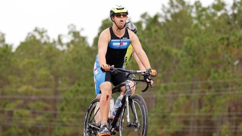 Chris Nikic competes in the bike portion with his guide, Dan Grieb, during Ironman Florida.