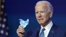 President-elect Joe Biden holds a protective mask as he speaks to the media after receiving a briefing from the transition COVID-19 advisory board on November 09, 2020 at the Queen Theater in Wilmington, Delaware. 