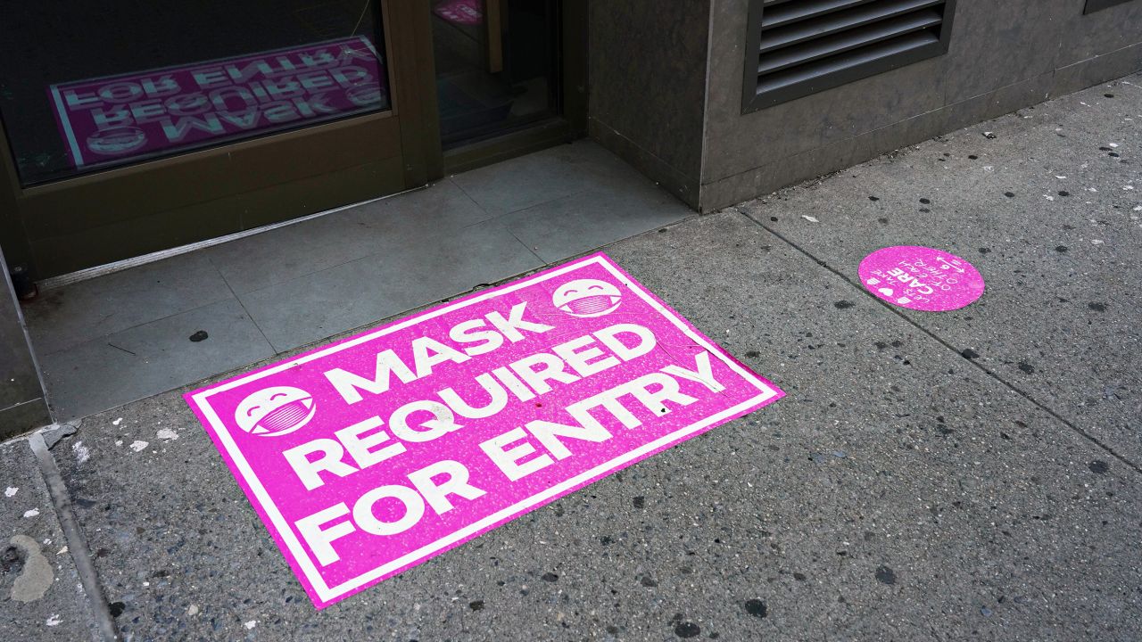 A 'mask required for entry' sign is displayed at the entry to a retail store on August 23, 2020 in New York City.