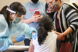 A girl receives the flu vaccination shot October 14, in Lakewood, California.