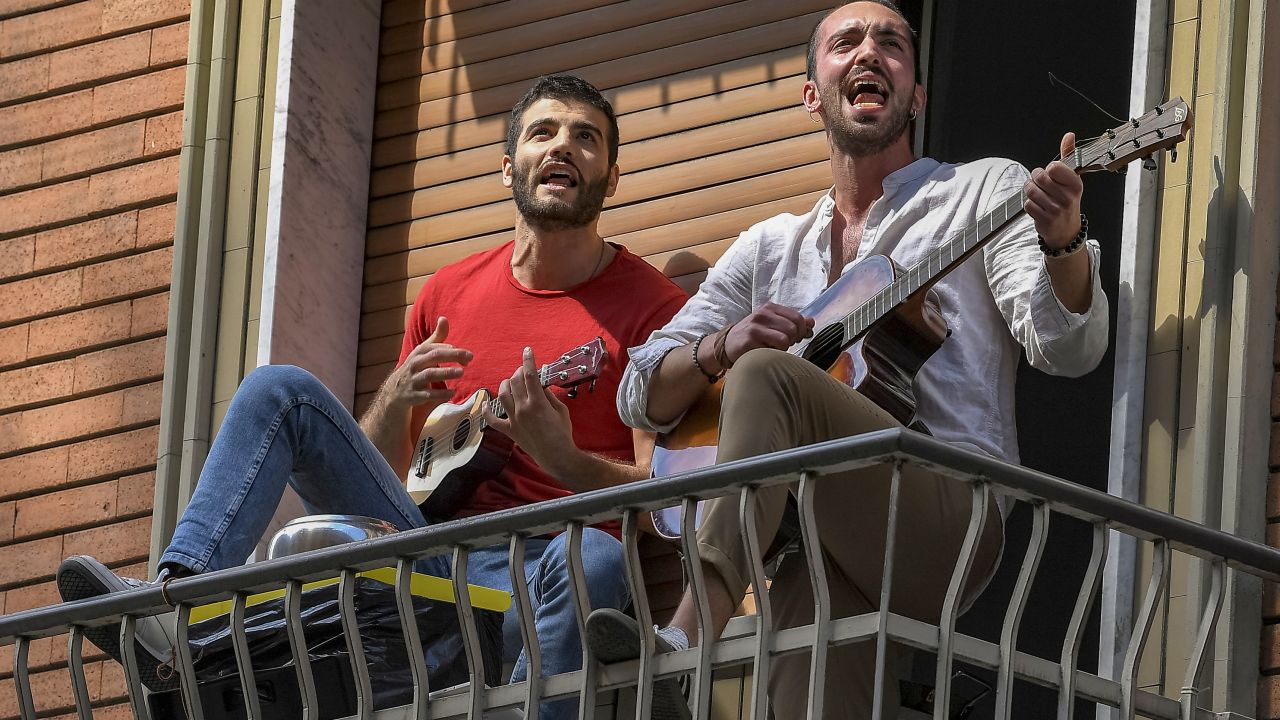 People play guitars and sing the song "Bella Ciao" to celebrate Liberation Day in Turin, Italy, on April 25, 2020. The day marks the Italy's liberation from the Nazis and fascists and the end of World War II for Italy. It is normally celebrated with a torchlight procession but that was canceled due to the pandemic.