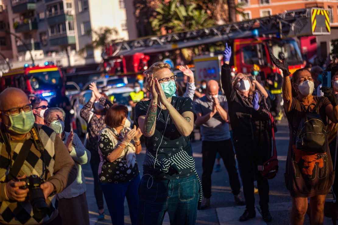 People applaud health care workers outside the Regional Hospital in Malaga, Spain, on May 17, 2020, to show their gratitude during the partial lockdown in the country.